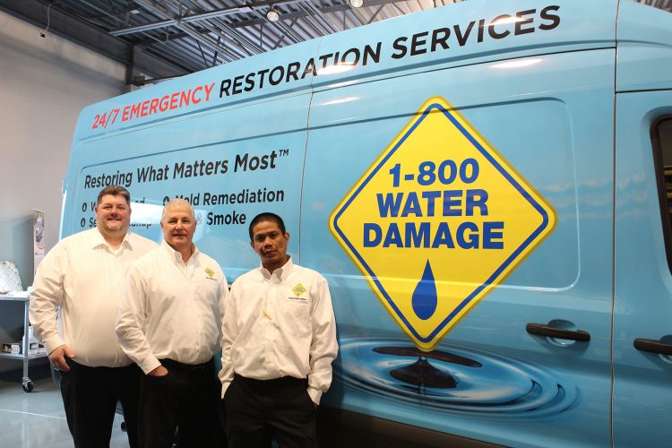 water damage restoration team with vehicle